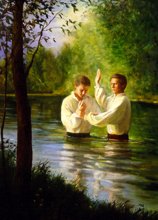 Joseph Smith and Oliver Cowdery stand in a river with trees on either bank. Both are wearing white shirts and dark trousers. Joseph holds Oliver's right wrist with his left hand and puts his right arm to the square.