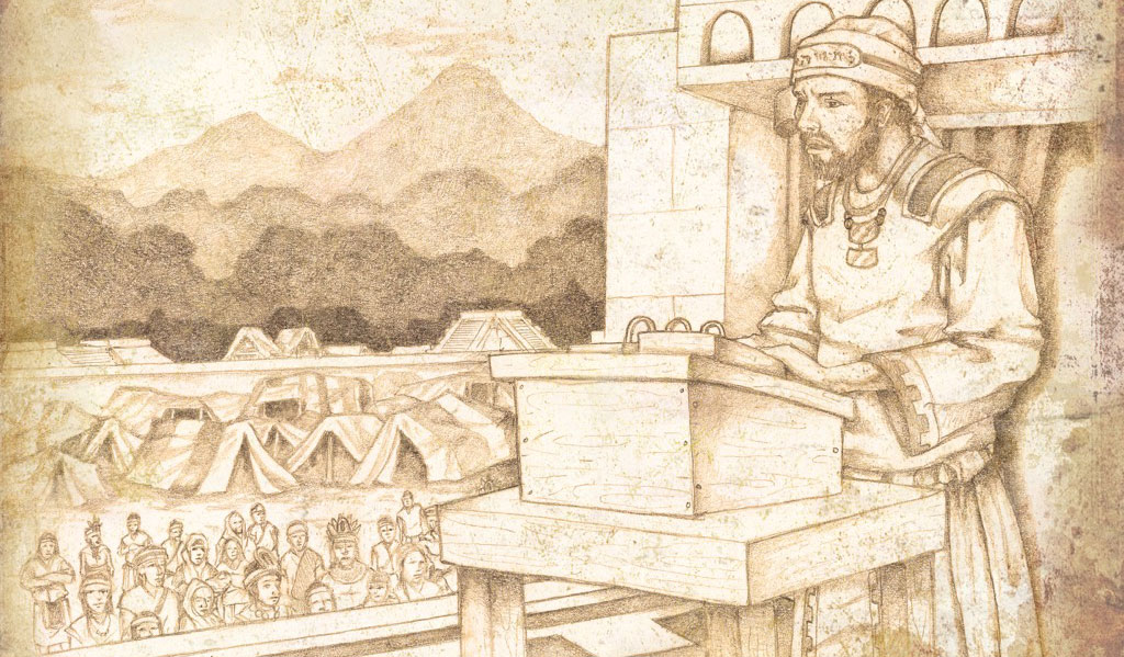 A man stands behind a wooden podium on a wooden table, which appears to have metal plates from which he is reading. The man wears a robe and a headband. In the background is a crowd of people, tents, other buildings, and layers of forest and mountains.